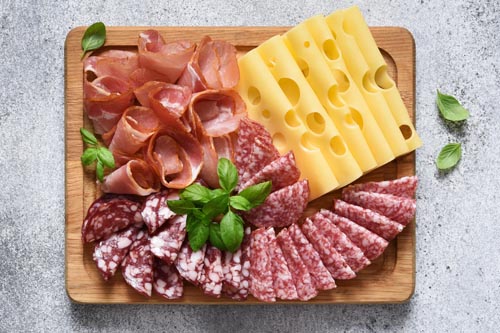 Delicacies.,Cheese,,Prosciutto,,Salami,On,A,Wooden,Square,Board,On